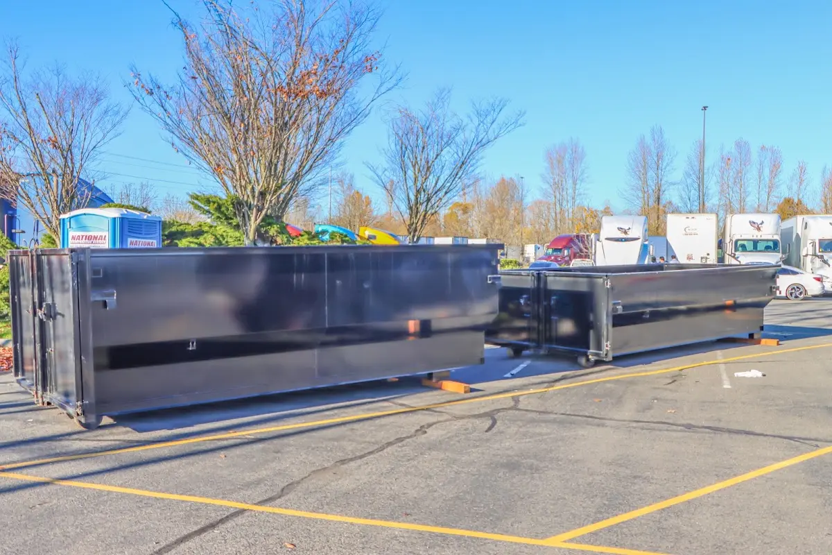 Professional dumpster rental service with roll-off container on residential driveway in Groveland